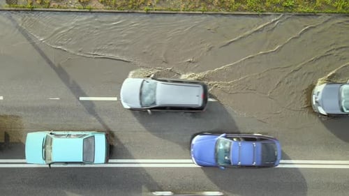 Aerial View of City Traffic with Cars Driving on Flooded Street After Heavy Rain Problems with Road