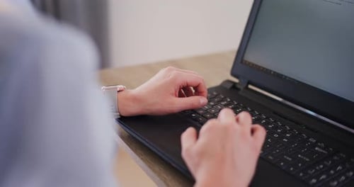 Hands Typing on a Laptop Computer Keyboard