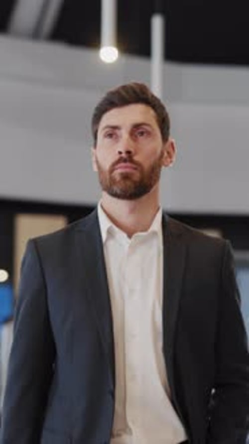 Young Handsome Entrepreneur Walking Confident Along Business Center Modern Hall with Corporate