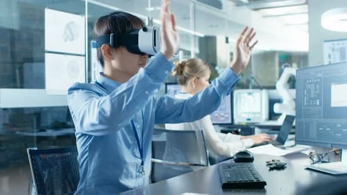 Computer Science Engineer wearing Virtual Reality Headset Works with 3D Modeling, Makes Gestures. I