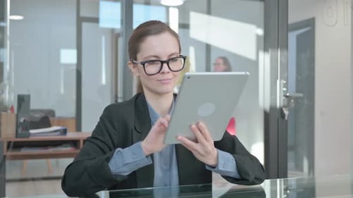 Woman Uses Tablet Device in Modern Office