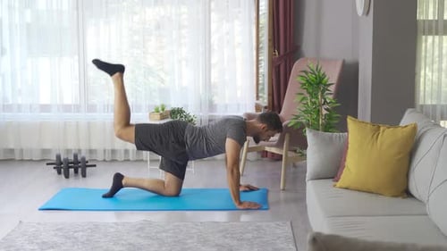 Man exercises, burns fat, burns calories, strength training, home fitness.