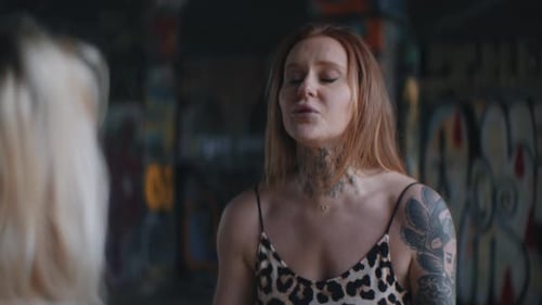 Women Quarreling With Each Other Against Graffiti Walls