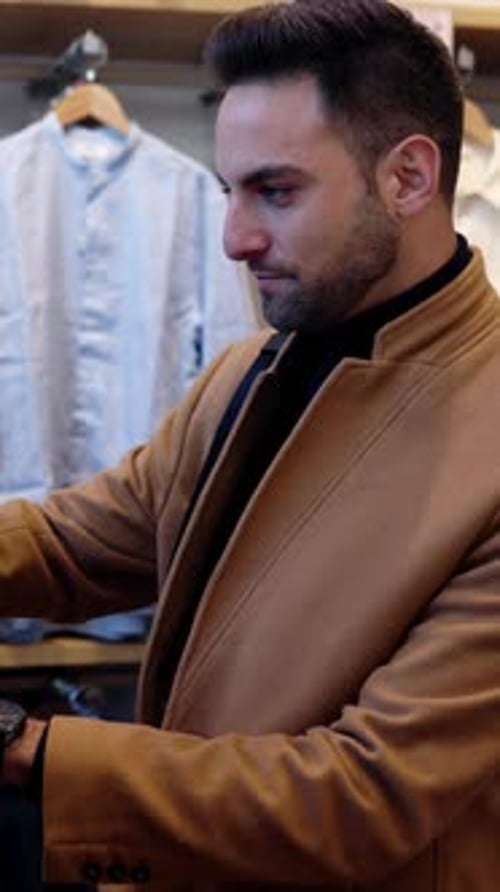 Handsome Trendy Businessman Shopping for New Clothes in Store