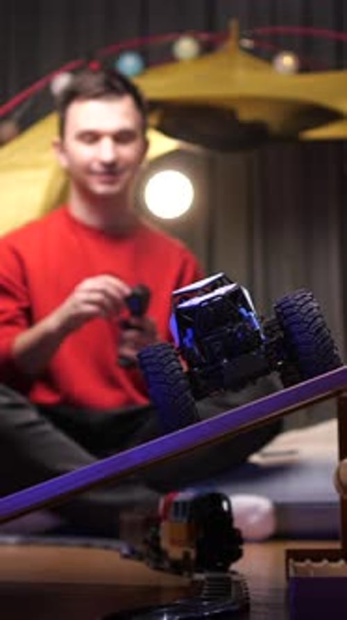 Young Adult Plays With Remote Control Toy Truck