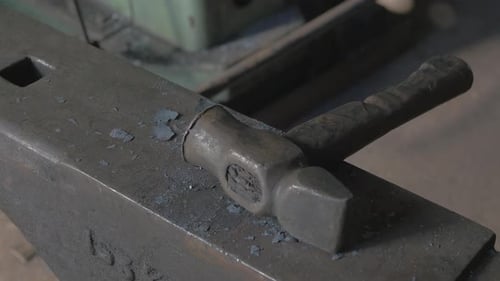 Hammer Resting on Anvil in Workshop
