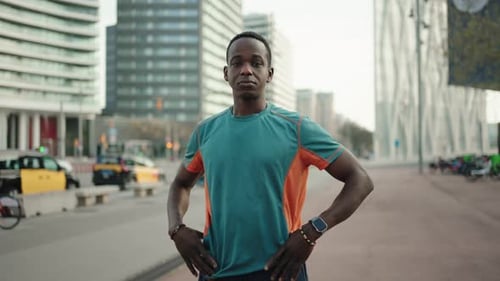 Portrait of Young African American Man with Arms Crossed in the City After Running and Practising