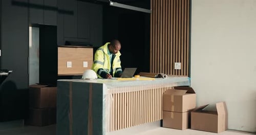 Laptop, renovation and typing with black man in kitchen for home improvement or upgrade project