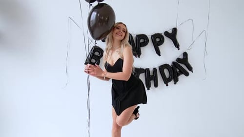 Blonde Woman Celebrates Birthday with Balloons and Lettering