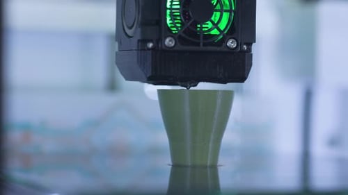 3D printer printing detail from plastic. Automatic three dimensional 3d printer performs plastic.