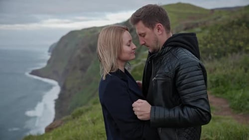 Romantic Couple Embracing on a Cliff Overlooking the Ocean