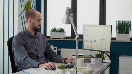 Man Working at Computer in Modern Office