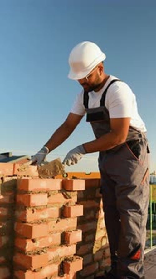 Indian Builder Constructing a New Home Wall