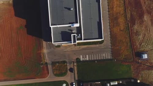School with Flat Roof and Brown Field in City District