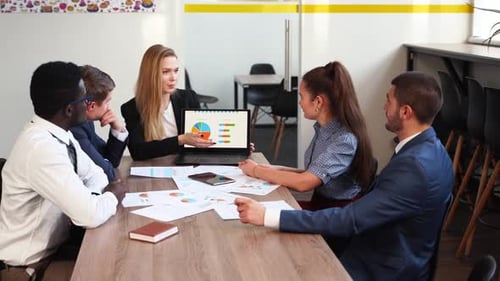 Professionals Collaborate During Office Presentation