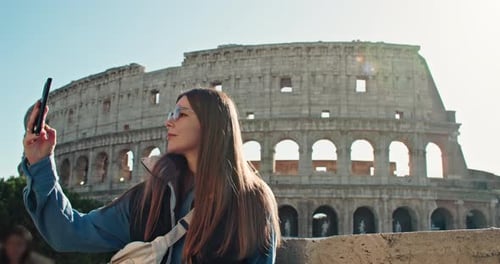Woman Takes Selfie at Colosseum in Italy