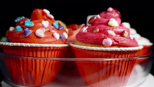 Festively decorated cupcakes on a rotating plate. Close-up.