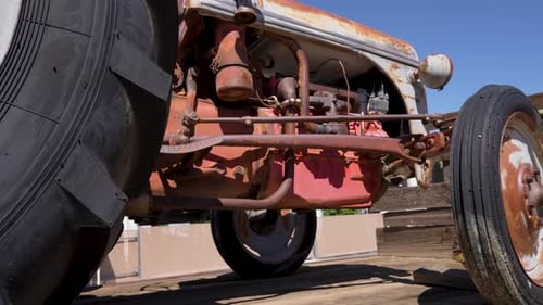 Looking at the engine from the underside of an antique tractor - sliding view