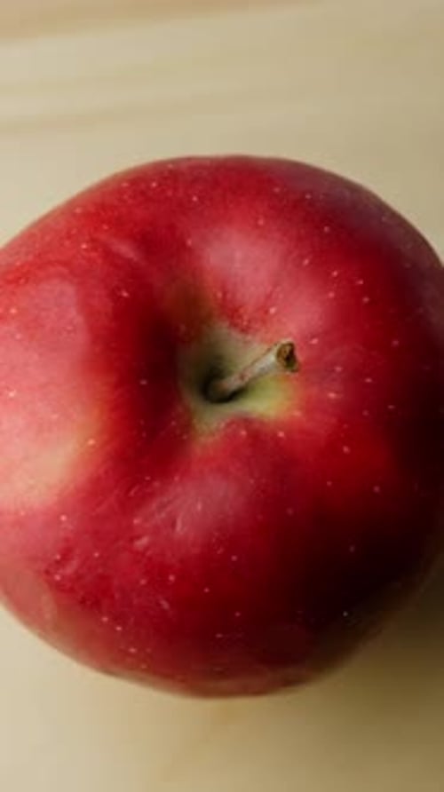 Vertical rotating shot of delicious red apple, close up of healthy fruit for a strong immune system