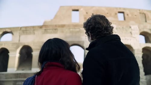 Couple Embracing in front of Ancient Colosseum in Rome