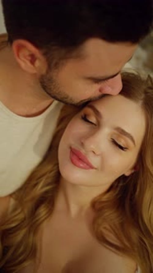 Romantic Man Kissing Woman's Forehead