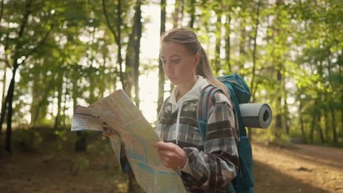 Woman Hiker Hiking with Map in Forest Female Tourist Finding Route Way Looking at Paper Map Walking