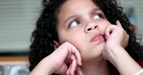 Child thinking about solution, pensive kid thoughtful girl