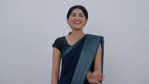 Smiling Woman Waving and Gesturing in Studio