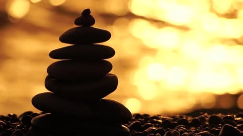 Balanced Rock Pyramid on Pebbles Beach Sunny Day and Clear Sky at Sunset
