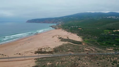 Sandy Beach Edged Rugged Coastline and Ocean Waves Aerial View Serene Seaside