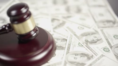 Judge's Gavel Resting on Pile of Money