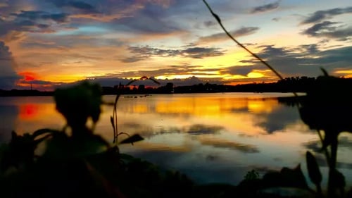 The beautiful sunset over the calm waters of the lake makes for a perfect view