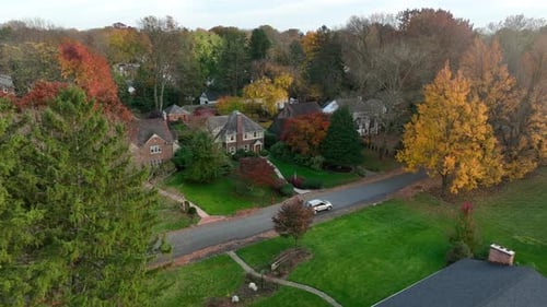 Car drives through upscale American suburb. Historic homes in luxury neighborhood in USA.
