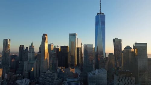 Aerial View of Sun Rising Over the New York City Skyline Casting Long Shadows From Skyscrapers of