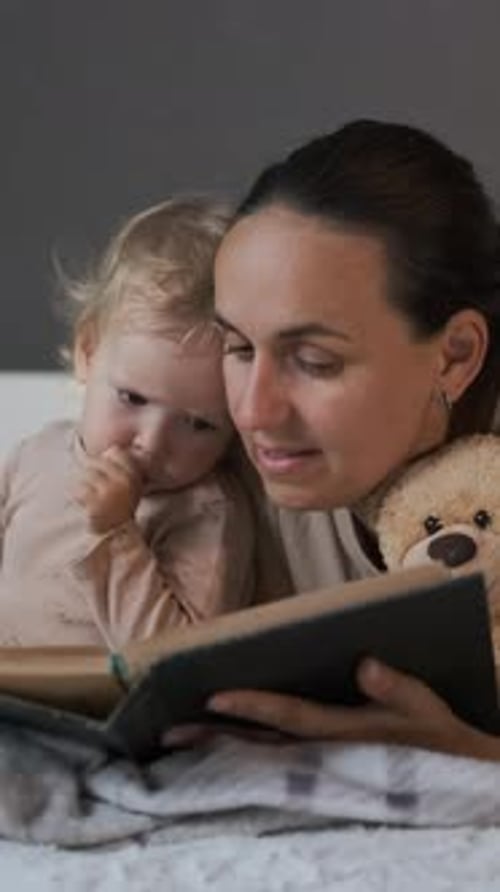 Woman Reading Book To Child Indoors