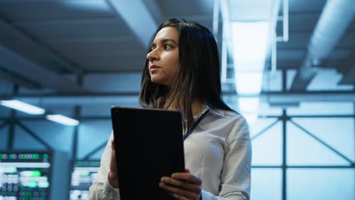 Software Developer Walking in Data Center Using Tablet