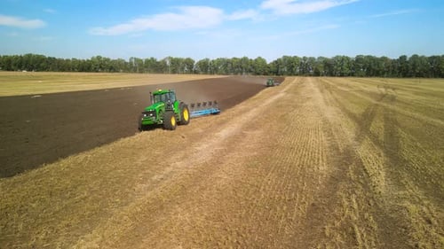 Tractors plowing the field in Ukraine