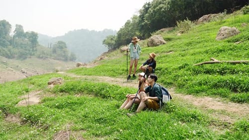 Friends Hiking Through Picturesque Green Rural Hills