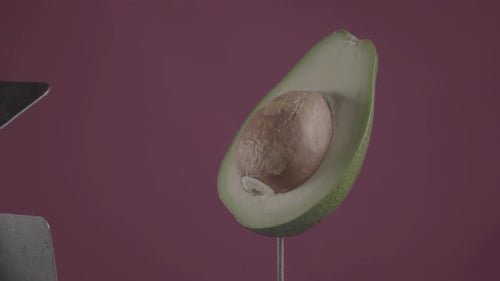Avocado Rotating with Loop on Fuchsia Screen for Chroma Key