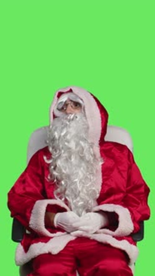 Vertical Video Front View of Santa Claus Character on Chair