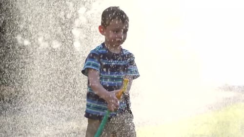 Young Boy Spraying Hose 3-4