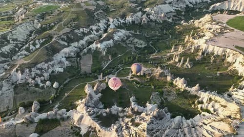 Hot Air Balloons Fly Over the Mountainous Landscape of Cappadocia Turkey