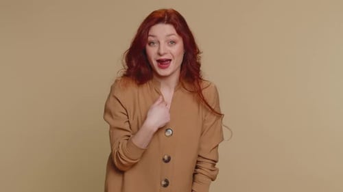 Woman Pointing to Camera and Looking with Playful Happy Expression Making Choice Showing Direction