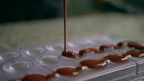 Pouring Melted Chocolate into a Candy Mold