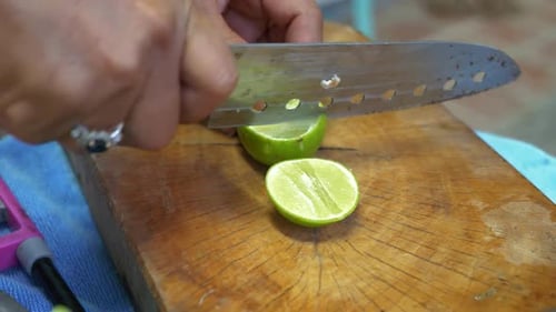 Cutting a Lime on a Wooden Cutting Board