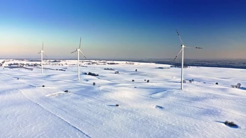 Wind turbine on snowy field in winter. Alternative energy, Poland.