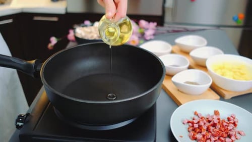 Pouring Vegetable Oil Into a Frying Pan