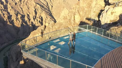 Aerial View Of Couple Watching The River From The Glass Terrace