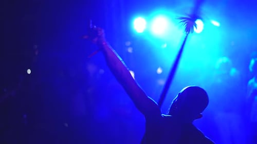 Shirtless Man Performing with Fire at Night