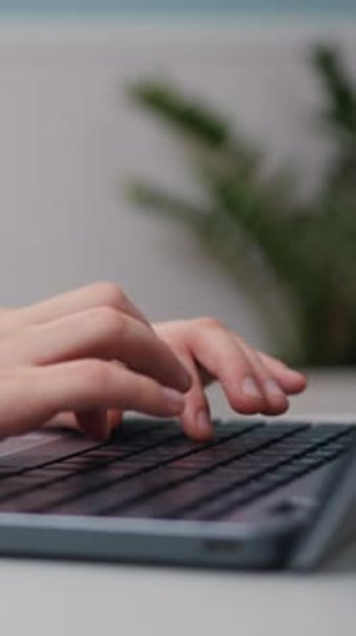 Closeup of Hands Typing on a Computer Keyboard Student Searching Information at Living Room at Home